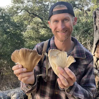 Kevin Smith of Catch N Cook California holding two oyster mushrooms